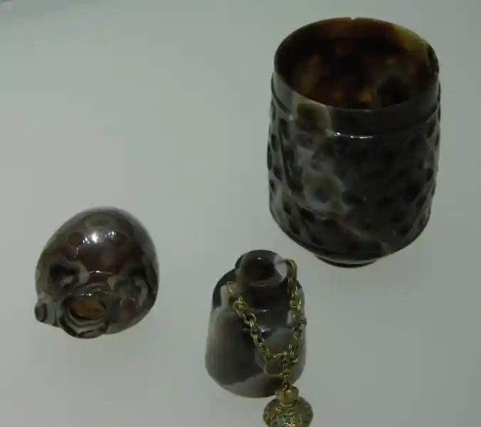 Brown cup with geometrically derived crosses and small vases